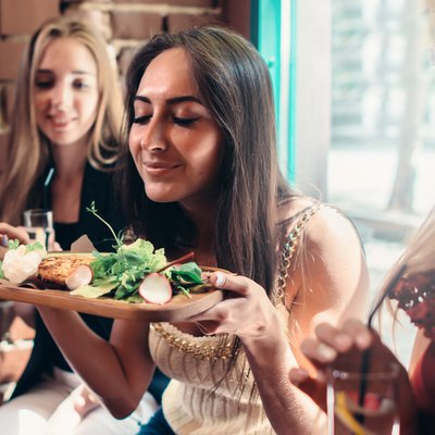 Group of girls reverse dieting and having lunch restaurant