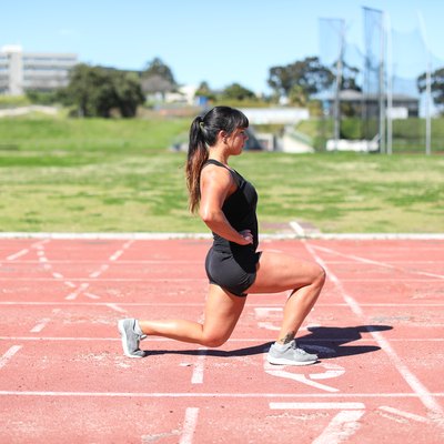 a Fit young woman training at the track.