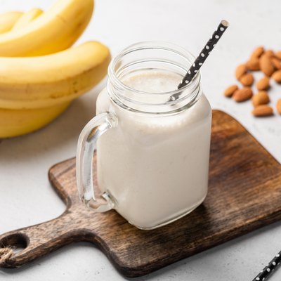 Banana protein smoothie in drinking glass