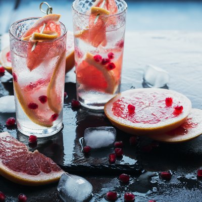 Grapefruit and pomegranate cocktail or mocktail, refreshing summer drink with crushed ice