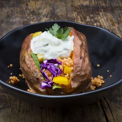 Sweet potato Kumpir withbell pepper, red cabbage, couscous, yoghurt sauce and parsley