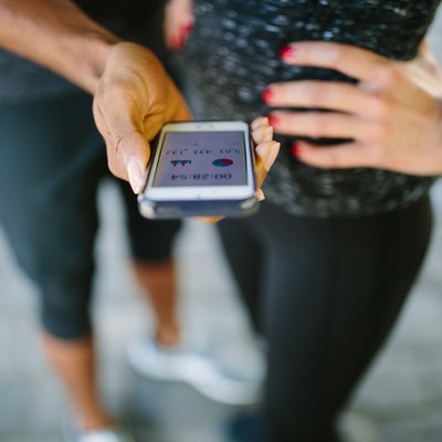 Young people checking their fitness progress on smartphone
