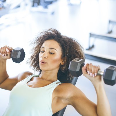 Young Woman Weightraining at the Gym