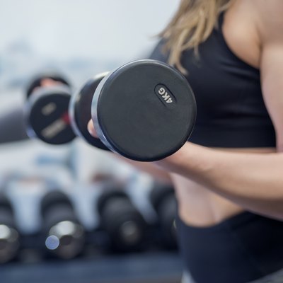 Gym woman Exercising with barbells