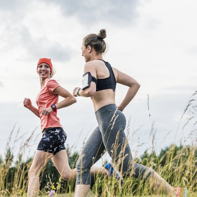 Two women running in the countryside