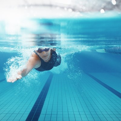 Swimmer racing in pool