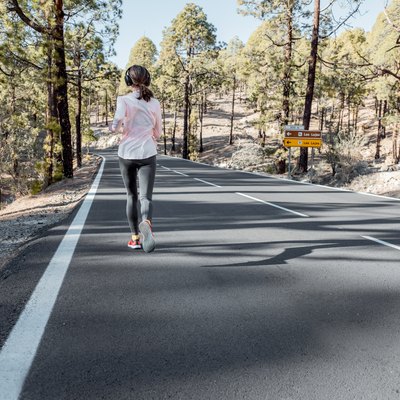 Woman jogging on the mountain road