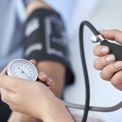 Close view of a nurse taking a patient's blood pressure