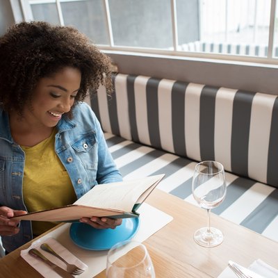 woman looking at a menu in a restaurant