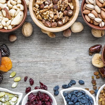Mix of dried fruits and nuts on rustic wooden background