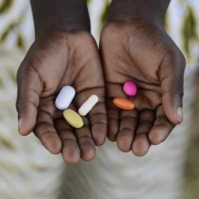 Healthy Lifestyle Medicine African American Woman Holding Colorful Pills Background