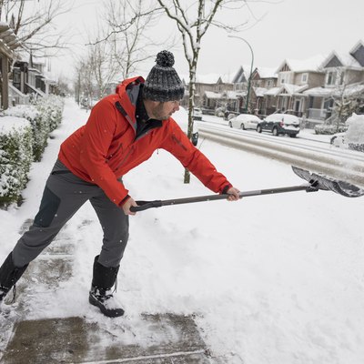 Man shoveling snow in winter and burning calories