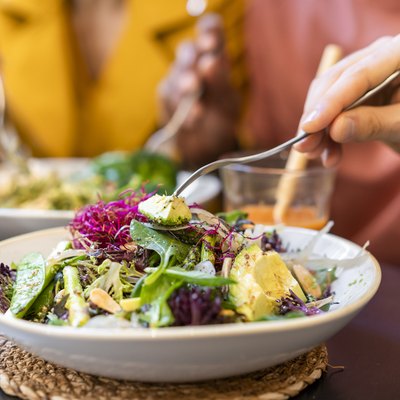 Close-up of people having healthy lunch in a restaurant