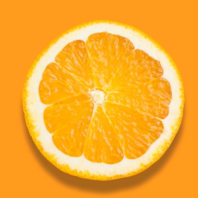 Close-Up Of Orange Slice Over Orange Background