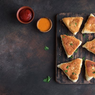 fried vegetarian samosa with sauces