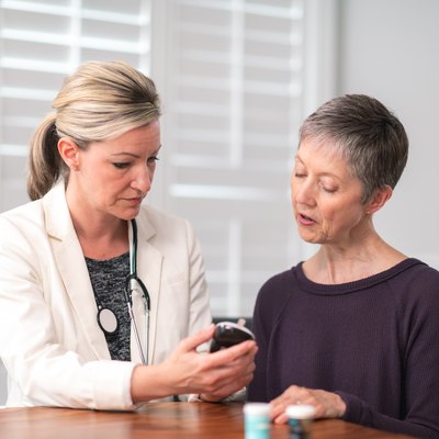 Female doctor consults with female patient about normal blood sugar range for women