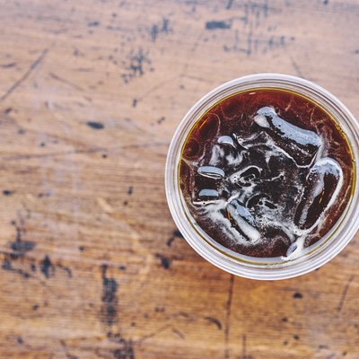 Directly Above Shot Of Cola In Glass On Wooden Table