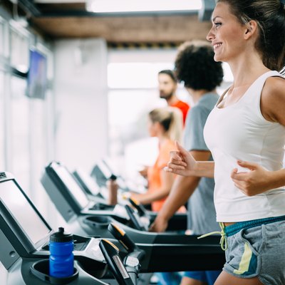 Group of friends exercising on treadmill machine