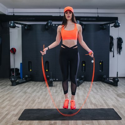 Young fit woman jumping a rope at a gym