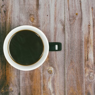 Directly Above Shot Of Black Coffee On Wooden Table