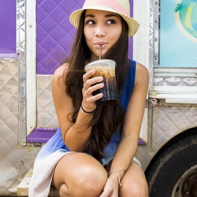Woman cutting 300 calories by drinking an iced coffee rather than a Frappuccino
