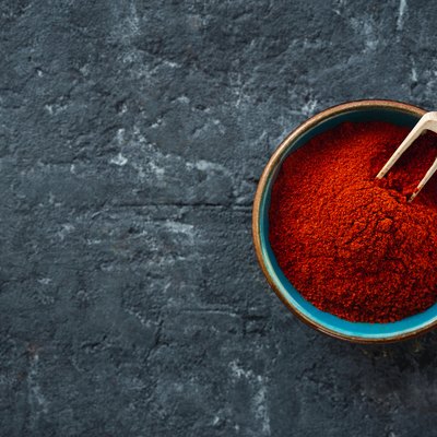 Chili pepper powder on dark background copy space top view