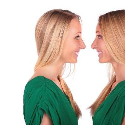 Twin girls smiling face-to-face
