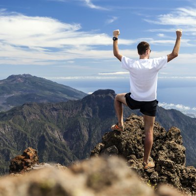 Trail runner success, man running in mountains
