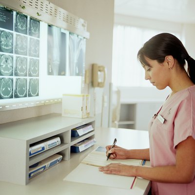 Nurse looking at paperwork in x-ray examination room