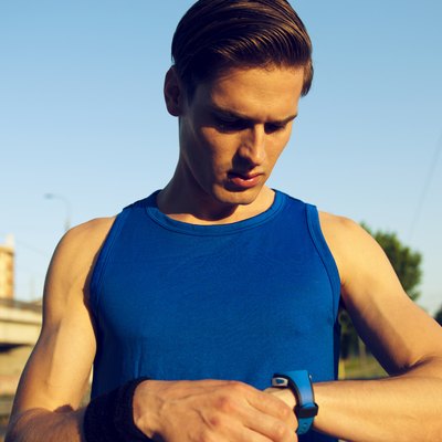 Handsome athlete checking pulse