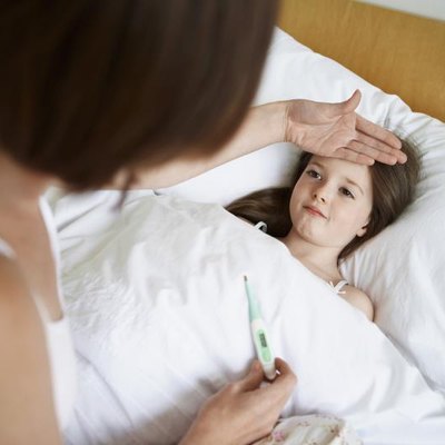 A mother, her daughter's temperature, a digital thermometer