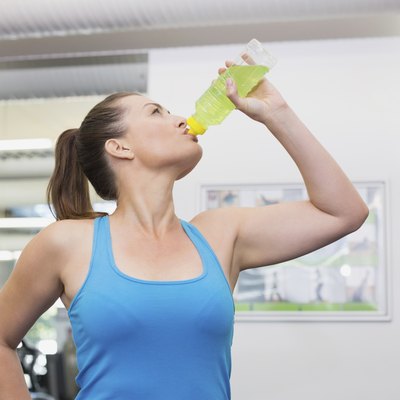 Fit brunette drinking energy drink