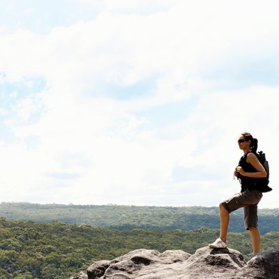 Woman Standing on a Mountain Summit Looking at View