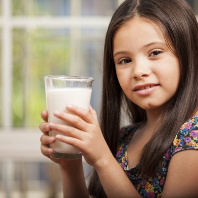 Cute girl with a glass of milk