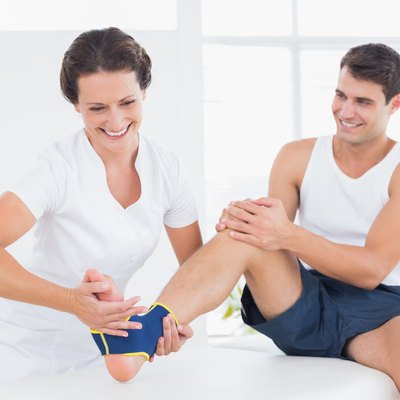 Doctor examining her patient foot