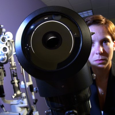 Ophthalmologist with keratometer and refractor