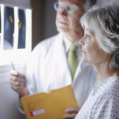 Doctor Discussing X-Rays with Middle Aged Woman