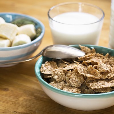 Delicious and healthy wheat flakes in bowl with milk
