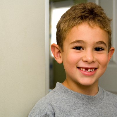 Proud young boy with newly lost teeth.