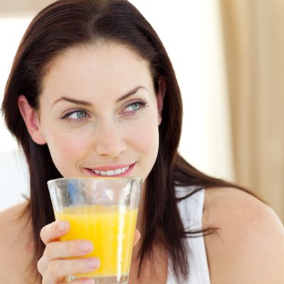 Attractive woman drinking orange juice