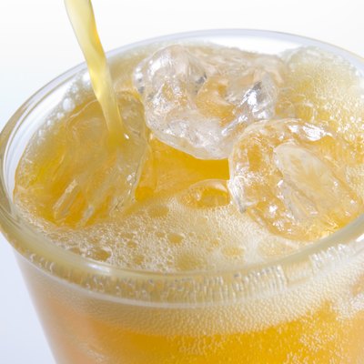 Pouring Orangeade Into A Glass Of Ice