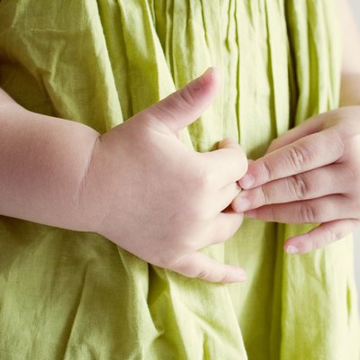 Child putting hands on stomach