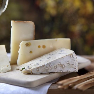 several blocks, cheese, a cutting board