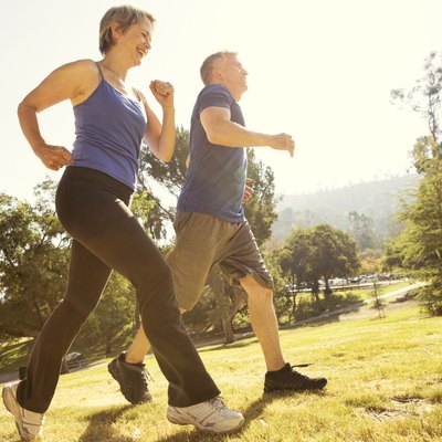 Mature couple power walking in park