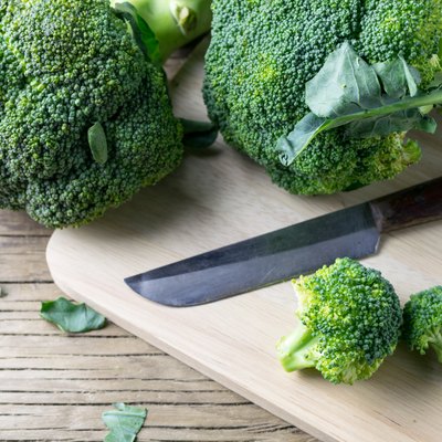fresh broccoli on a cutting board and knife