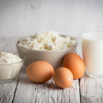 Fresh dairy products and eggs on rustic wooden table