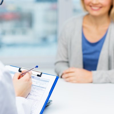 close up of doctor and woman meeting at hospital