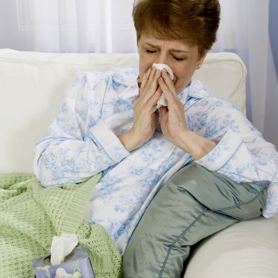 Woman blowing nose