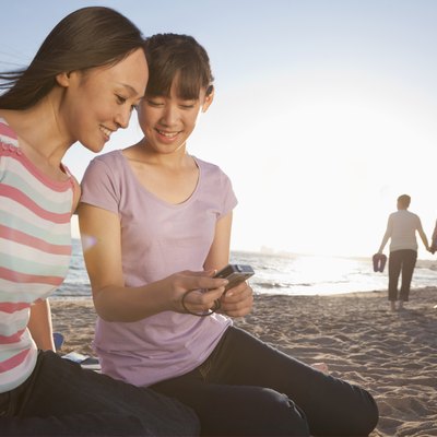 Mother and Daughter looking at camera on the beach
