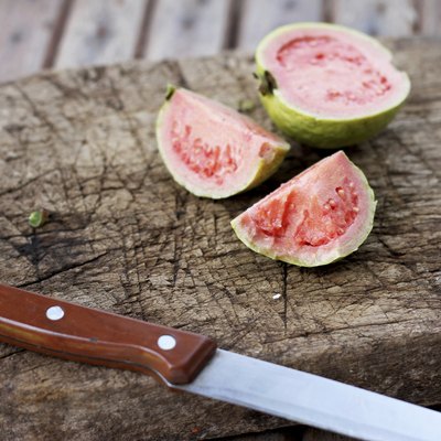Guava on old wooden chopping board